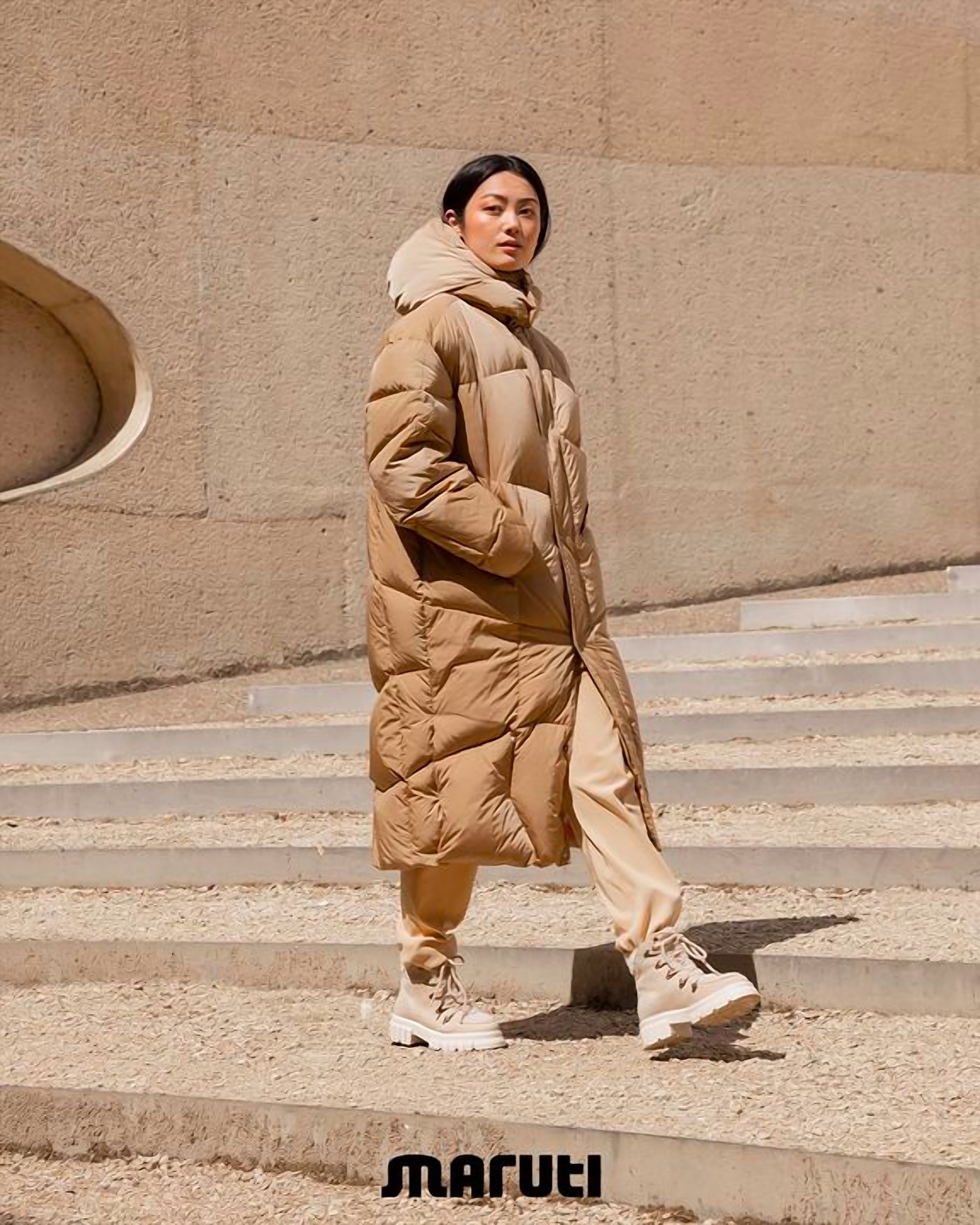 Model in a long coat on stone steps, Maruti campaign